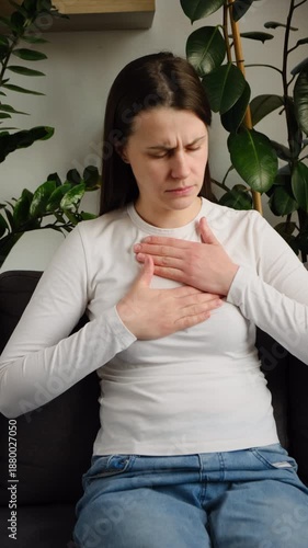 Wallpaper Mural Unhealthy young caucasian woman having severe chest pain while sitting alone on couch, sad worried female suffers from heartache at home, infarction or heart disease concept Torontodigital.ca