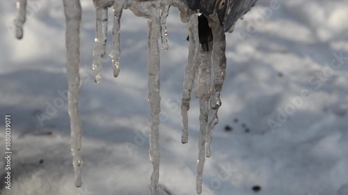The icicles on the roof are melting.
