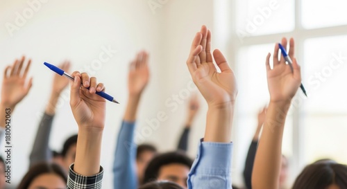 Group of students raising hands to answer question