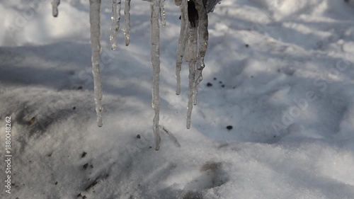 The icicles on the roof are melting.
