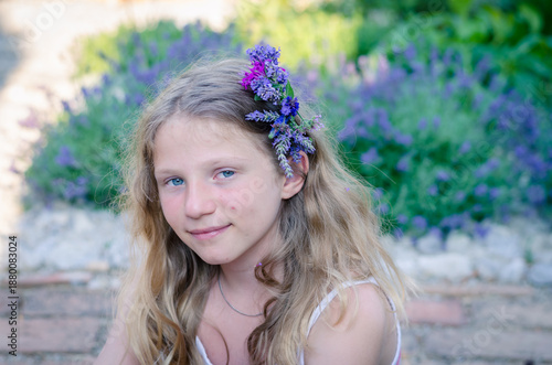 portrait of teenage girl with long blond hair and flowers in hair