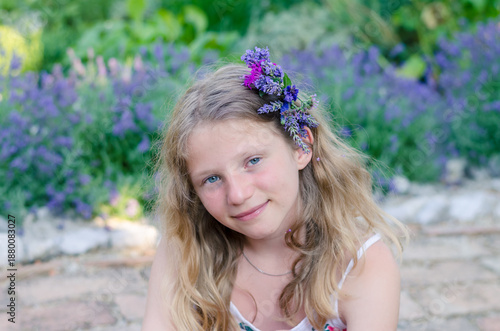 portrait of teenage girl with long blond hair and flowers in hair