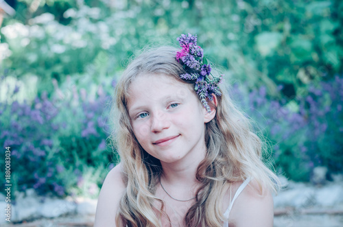 portrait of teenage girl with long blond hair and flowers in hair