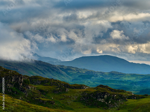 Rocky terrain blends with lush greenery in a serene, untouched landscape.