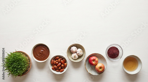Nowruz haft sin ingredients on white. Nowruz haft sin bowls with sabzeh, samanu, dates, garlic, apples, sumac, tea, clean copy space for Nowruz Persian New Year banner, spring equinox theme