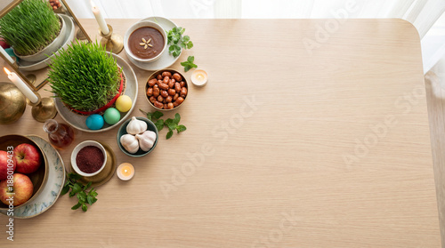 Nowruz haft sin table with copyspace. Nowruz setting features sabzeh, candles, apples, garlic, sumac, samanu, colored eggs, mirror, for Persian New Year banner, spring equinox mood
