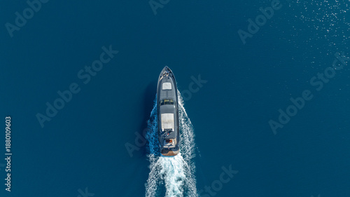 Photos Ocean Cruiser: An aerial, bird's-eye view captures a sleek cruiser gliding across the vast expanse of deep blue sea, creating a trail