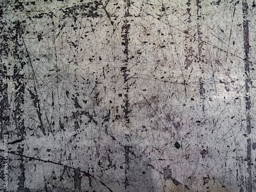 Фотография Heavily scratched and worn gray metal surface showing industrial wear patterns a