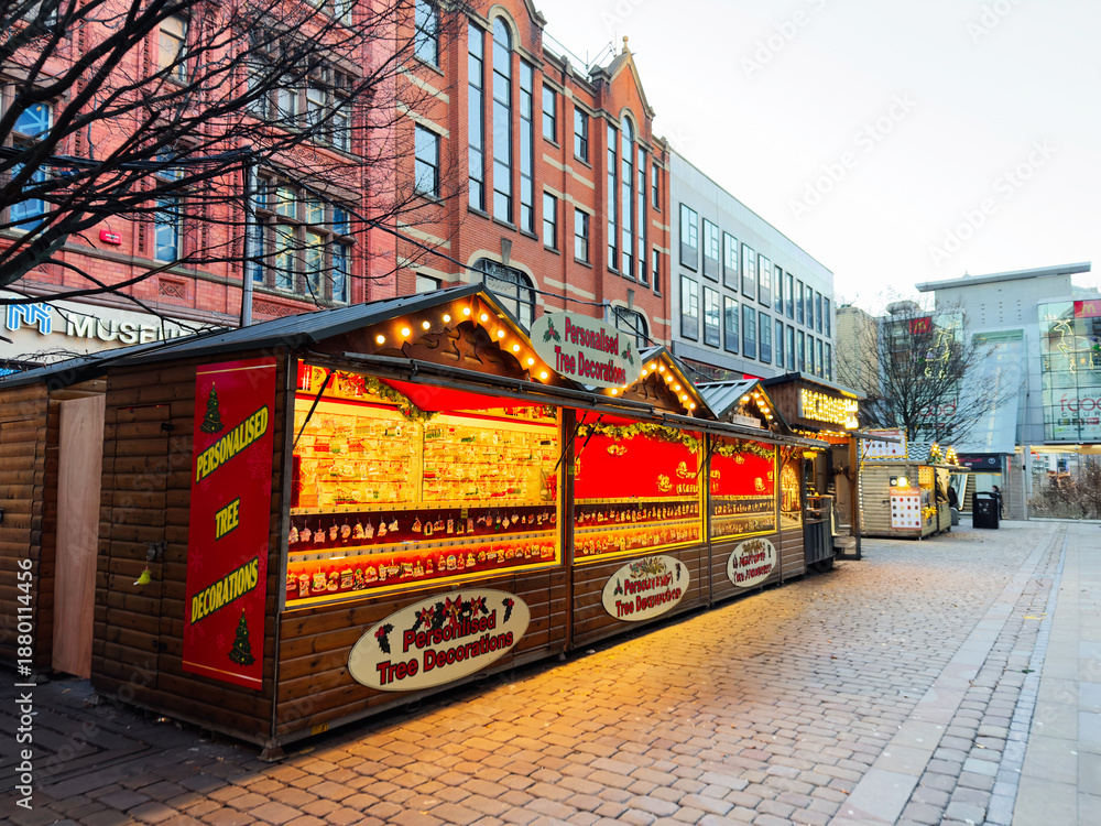 Fototapeta premium Manchester Christmas market stalls with personalized tree decorations and festive lights