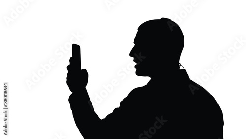 Silhouette of a man speaking into a smartphone while holding it vertically against a bright background