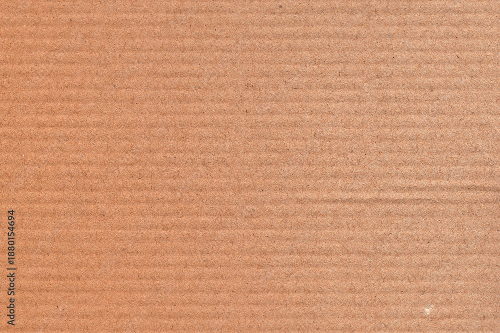 Fototapeta premium Natural brown kraft paper texture background with subtle horizontal grain and recycled fiber details. Minimal cardboard surface ideal for packaging design, eco branding, stationery, mockups, posters.