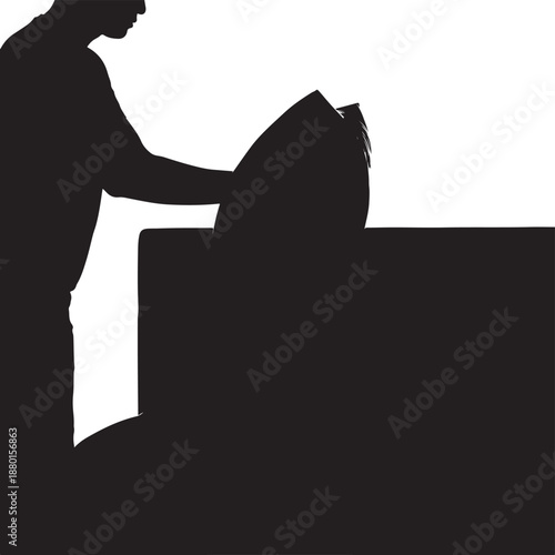 Silhouette of a man working over a table surface, craft project or household chore concept
