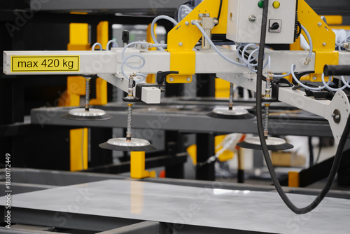 Valokuva Vacuum lifting beam with multiple suction cups handling large sheet on automated