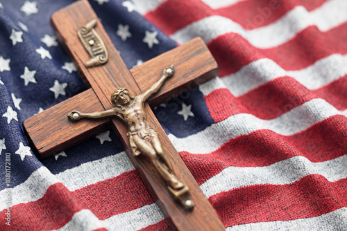 Wooden crucifix on wavy American flag