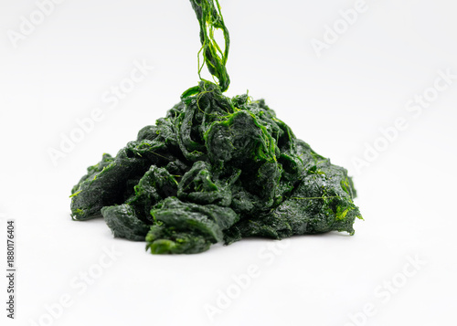 Image of dark green seaweed in a round shape on a white plate, showing a fine, delicate thread-like texture. Korean food ingredients used.