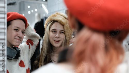 Two teenage friends are shopping for warm winter clothes.