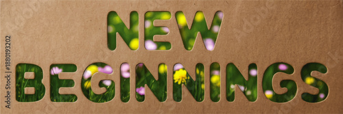 New Beginnings inspirational word art with spring flowers and green grass inside cutout text on brown paper background