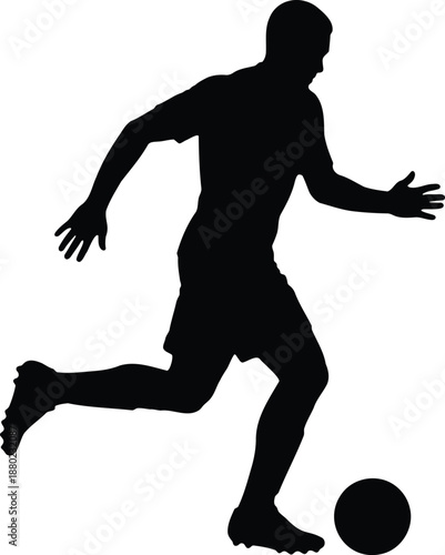 Silhouette of a person kicking a ball in a dynamic pose