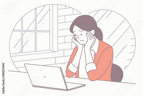 Woman feeling stressed while looking at her laptop computer at a desk