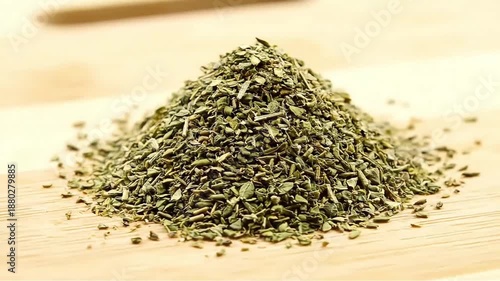 A fragrant pile of dried oregano herbs sits on a wooden surface showcasing natural ingredients for cooking seasoning and healthy eating concepts