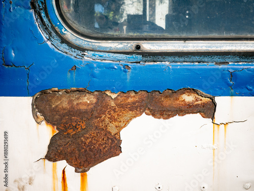 Peeling Paint on Old Metal Surface with Yellow Hinge and Rust Damage