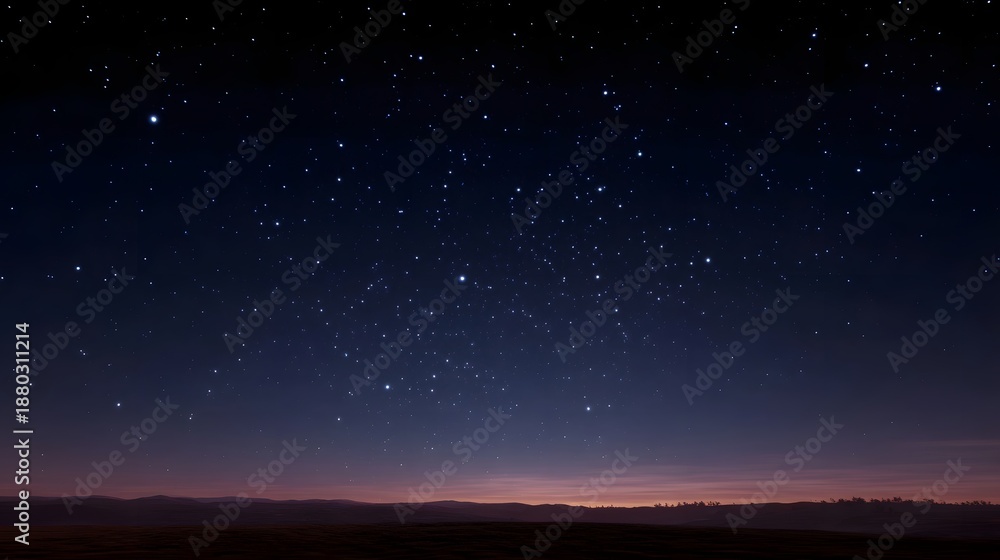 Fototapeta premium A vast clear night sky filled with countless twinkling stars above a dark tranquil horizon at twilight