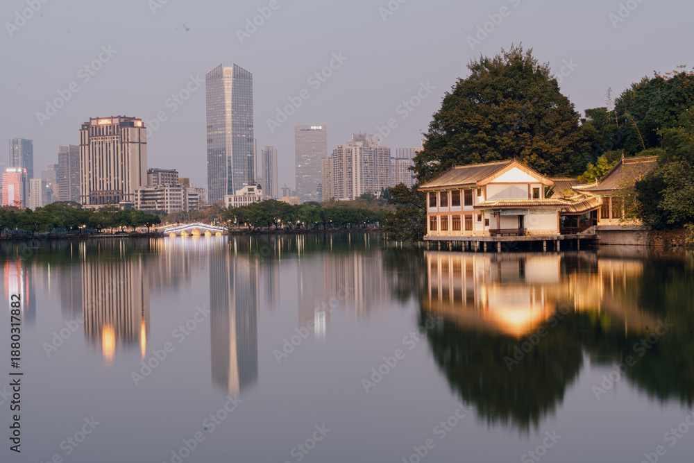 Obraz premium City Skyline and Traditional Pavilion Reflecting in Calm Lake - Huizhou West Lake