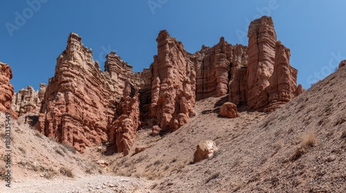 Red Rock Hoodoos Against a Clear Blue Sky in a Barren Landscape Sandstone Formations with Layered Texture and Rocky Terrain in Utah State Under Bright Sunlight