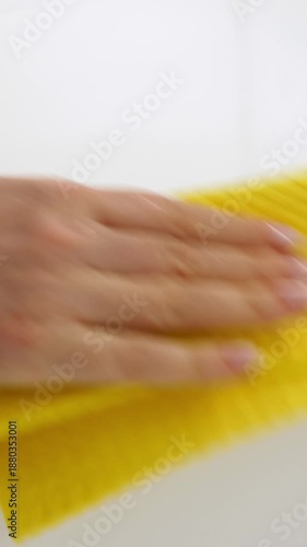 Wallpaper Mural Washing white acrylic countertop with yellow rag. Unrecognizable woman cleaning kitchen, closeup. Vertical footage Torontodigital.ca
