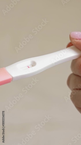 Wallpaper Mural Woman holding in hands pregnancy test. Check quick pregnancy test kit. She is expecting a baby. Vertical footage Torontodigital.ca