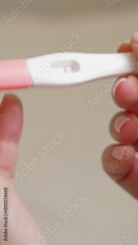 Wallpaper Mural Woman holding in hands pregnancy test. Check quick pregnancy test kit. She is expecting a baby. Vertical footage Torontodigital.ca