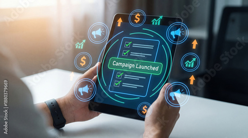 фотографія Person holding tablet with campaign launched on screen and marketing icons float