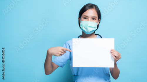 Female Nurse Wearing Mask Holding Blank Sign on Blue Background