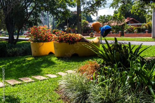 Εκτύπωση καμβά Giant yellow decorative Dutch clog planters in a public garden in Holambra II, Paranapanema, Brazil, symbolizing the city's rich Dutch immigrant heritage and cultural tradition