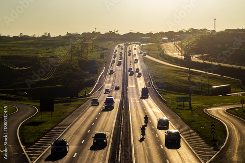 Wallpaper Mural Marilia, SP, Brazil, November 19, 2025. Highway SP-294 in Marilia, at sunset. Intense traffic of cars and trucks flows through the green landscape, illuminated by the golden hour light. Torontodigital.ca