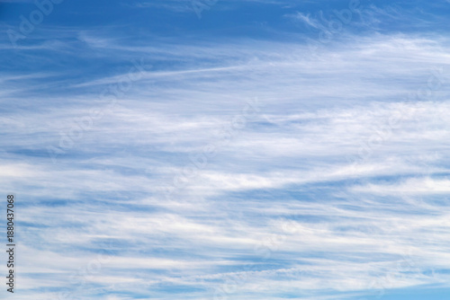 Clear Blue Sky With Soft White Clouds Over a Calm Day