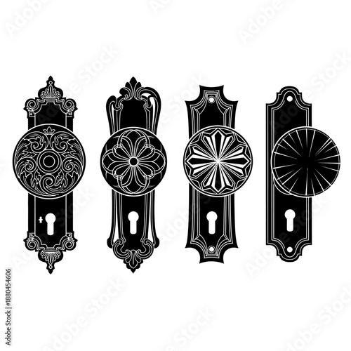 Four antique black door knobs with ornate detailing and keyholes displayed