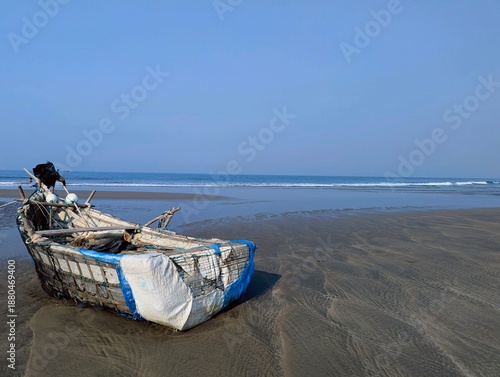 Fotografija Rustic Net-Wrapped Wooden Fishing Boat on Tropical Sandy Shore