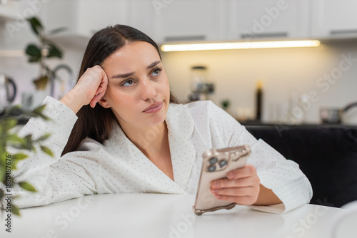 Canvastavla Young woman at home scrolls phone news feed bored unhappy low energy burnout doomscroll