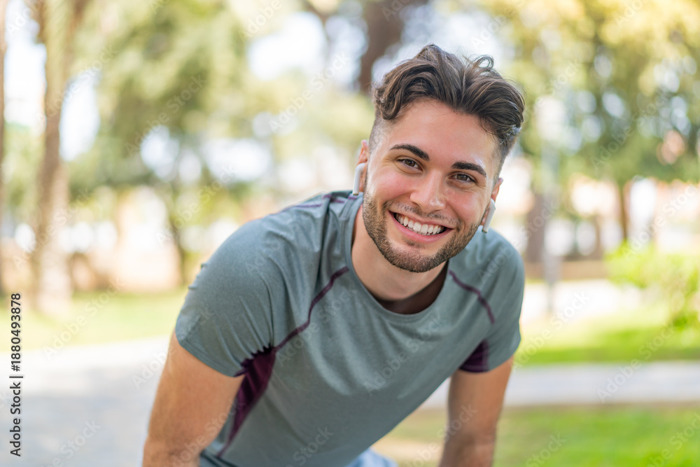 Fototapeta premium Young handsome man wearing sport wear with happy expression