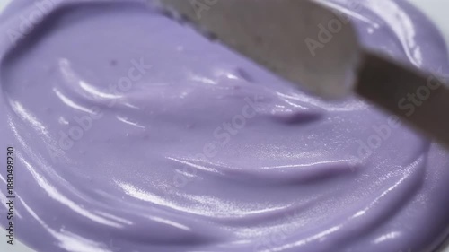 Purple cream spread with spatula smooth.