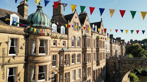 Festive bunting flags adorning classic architecture facade sunny day