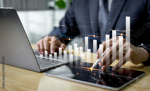 Tableau sur toile A financial adviser analyzes market diagrams on a tablet, viewing charts and graphs with technology icons to express economic growth, future trends, and success in digital finance strategy