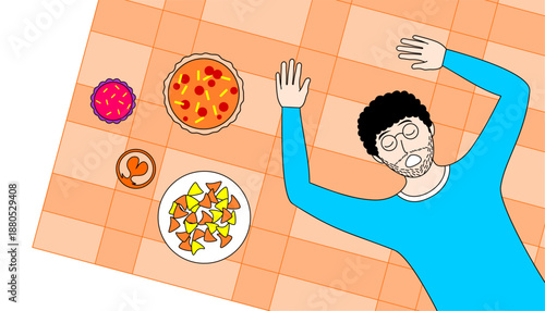 A man is laying on a table with a plate of food in front of him