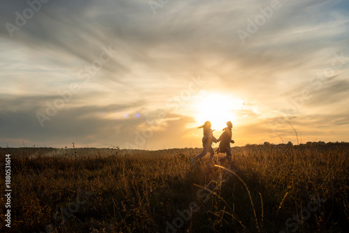 Wallpaper Mural Young couple Silhouetted Figures in a Golden Hour Landscape Torontodigital.ca