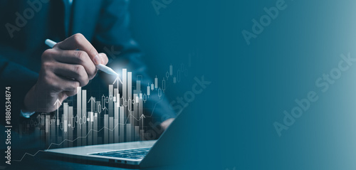 Business analyst using digital pen to analyze financial growth chart on laptop, representing data analytics, investment strategy, stock market performance, business finance, and modern technology.