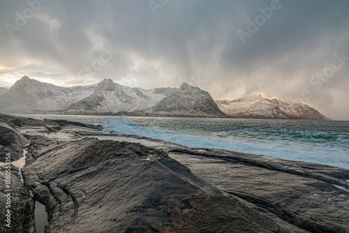 Cloudy day on the coast of Senja, Norway, with dramatic cliffs, rough sea waves, and a moody sky creating a powerful, atmospheric Nordic seascape shaped by wind and nature