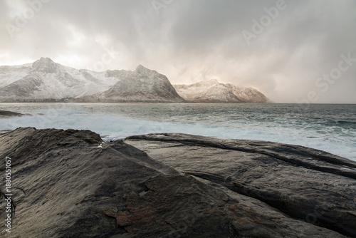Cloudy day on the coast of Senja, Norway, with dramatic cliffs, rough sea waves, and a moody sky creating a powerful, atmospheric Nordic seascape shaped by wind and nature