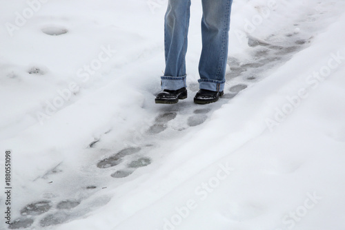 Wallpaper Mural Danger of slipping. Person in chunky platform leather boots walking on snowy icey road
 Torontodigital.ca
