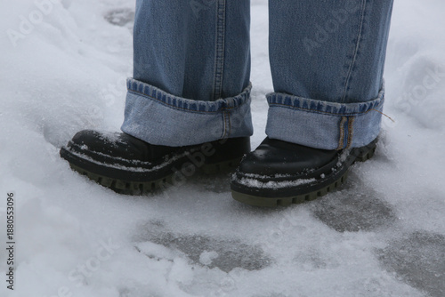 Wallpaper Mural Danger of slipping. Person in chunky platform leather boots walking on snowy icey road Torontodigital.ca